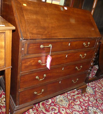 Lot 1381 - A George III mahogany slopefront four drawer...