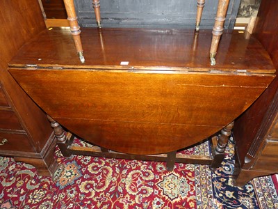 Lot 1384 - A joined oak drop leaf dining table, having a...