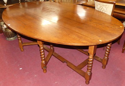 Lot 1407 - A joined oak drop leaf wake table, raised on...