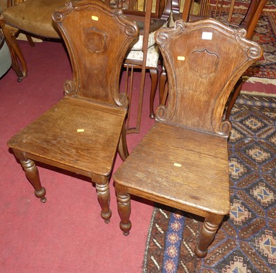 Lot 1456 - A pair of mid-Victorian oak panelled seat hall...