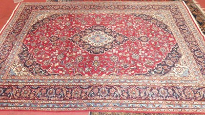 Lot 1500A - A Persian red ground Keshan rug, with central...