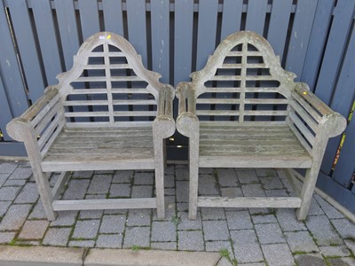 Lot 1495 - A pair of slatted teak Lutyens garden chairs,...