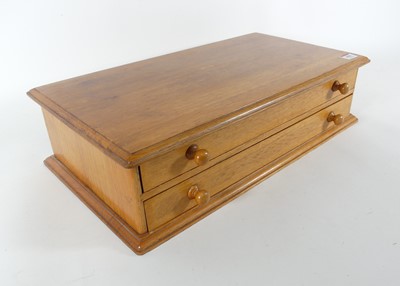 Lot 436 - A light oak two-drawer table-top chest,...