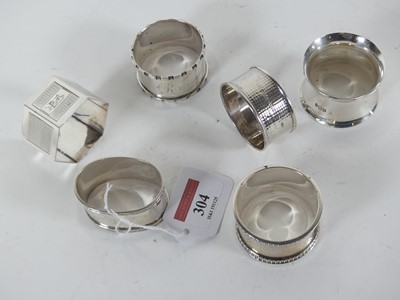 Lot 304 - A collection of silver napkin rings, weighable...