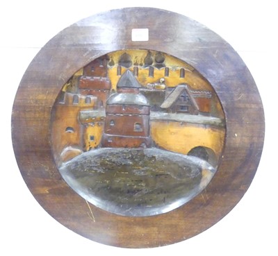 Lot 656 - A round wooden relief carved wall plaque,...