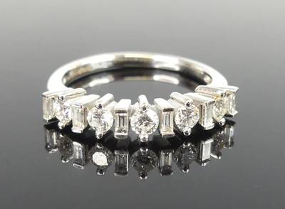 Lot 2518 - An 18ct white gold diamond half eternity ring...