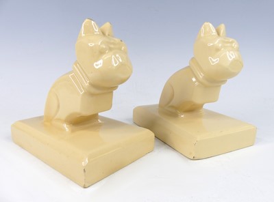 Lot 24 - A pair of Art Deco cream glazed earthenware...