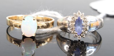 Lot 322 - A 14ct gold cabochon opal set dress ring, size...
