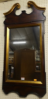 Lot 1196 - A mahogany and gilt decorated wall mirror, in...