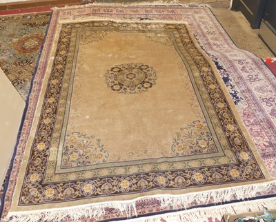 Lot 1209 - A Chinese silk rug, having a pale ground,...