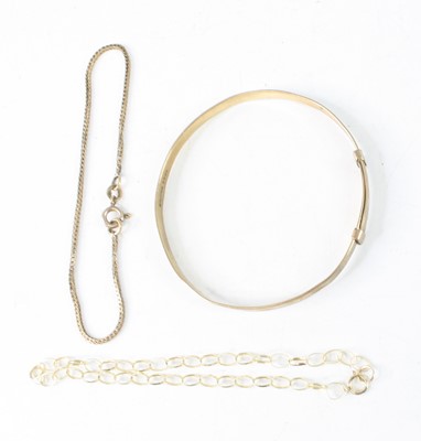 Lot 365 - A child's 9ct gold and engraved bangle,...