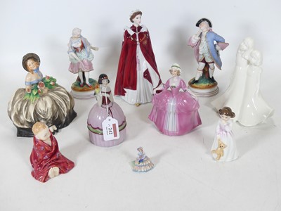 Lot 242 - A collection of porcelain figures, to include...