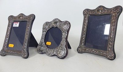 Lot 256 - A pair of silver-clad easel photograph frames,...