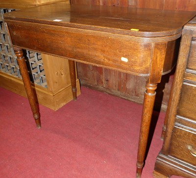 Lot 1253 - A Regency oak D-shaped fold-over card table,...