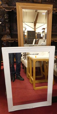 Lot 1144 - An ebonised framed and bevelled rectangular...