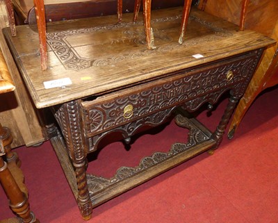 Lot 1292 - A joined and relief carved oak single drawer...