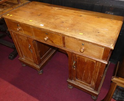 Lot 1305 - A rustic pine kneehole writing desk, having...
