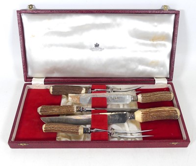 Lot 260 - A 20th century antler handled carving set, in...