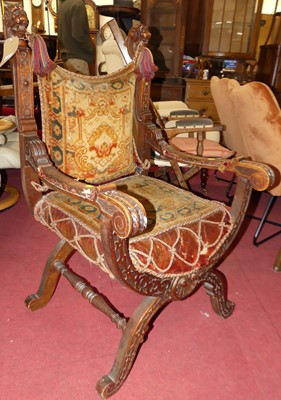 Lot 1367 - A Spanish carved oak X-frame open throne chair,...