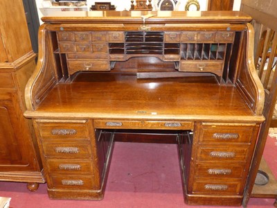 Lot 1418 - An early 20th century oak twin pedestal roll...