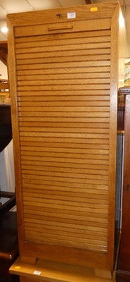 Lot 1435 - A 1930s blond oak tambour fronted office...
