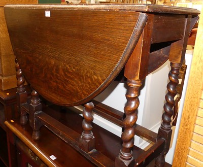 Lot 1437 - A 1920s oak barley twist drop leaf occasional...