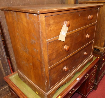 Lot 1452 - A rustic stained hardwood low chest of three...