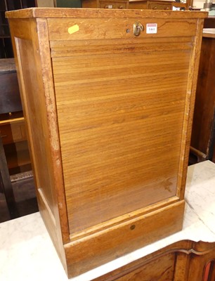 Lot 1461 - A light oak tambour fronted low office filing...