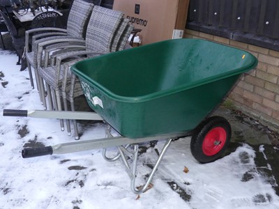 Lot 1468 - A tipping wheel barrow, the green plastic...