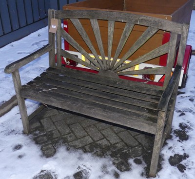 Lot 1477 - A slatted teak two-seater garden bench, width...