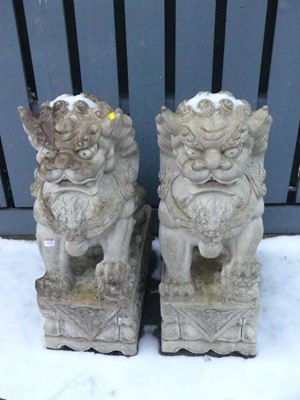 Lot 1478 - A pair of composite Eastern seated dog of fo...