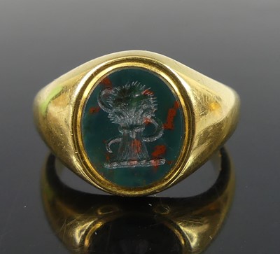 Lot 2505 - A yellow metal bloodstone set oval signet ring,...