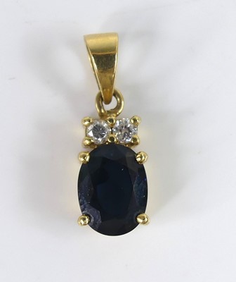 Lot 2515 - A yellow metal, sapphire and diamond pendant,...