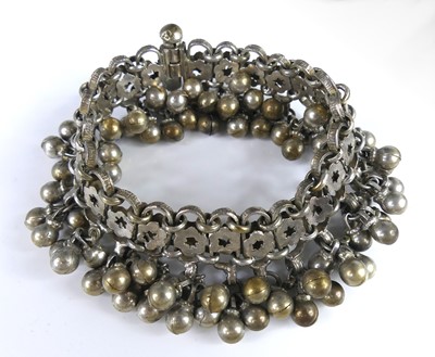 Lot 2549 - An African white metal bracelet with floral...