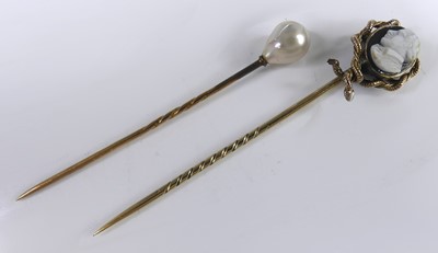 Lot 2551 - Two yellow metal stick pins, one having a 9 x...