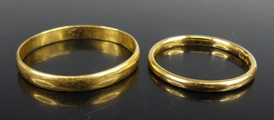 Lot 2566 - Two 22ct gold wedding rings, being a 3.1mm...