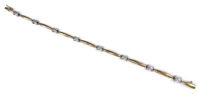 Lot 2558 - A 9ct yellow and white gold diamond bracelet,...
