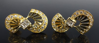 Lot 2577 - A pair of yellow metal figure-of-eight shaped...