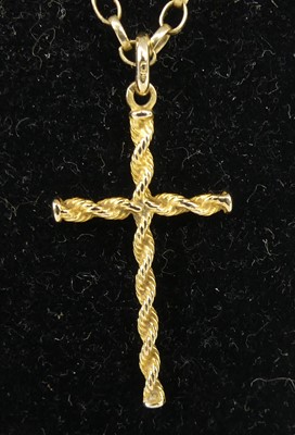Lot 2585 - A yellow metal ropetwist cross attached to an...