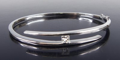 Lot 2592 - A white metal and diamond set hinged crossover...