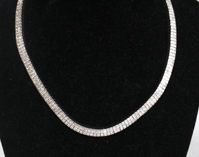 Lot 2609 - A white metal diamond set necklet, comprising...