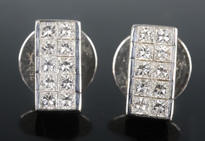 Lot 2610 - A pair of white metal diamond set ear studs,...
