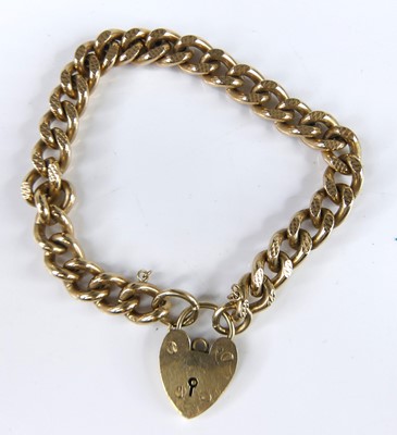 Lot 2640 - A 9 carat gold engraved curb link bracelet...