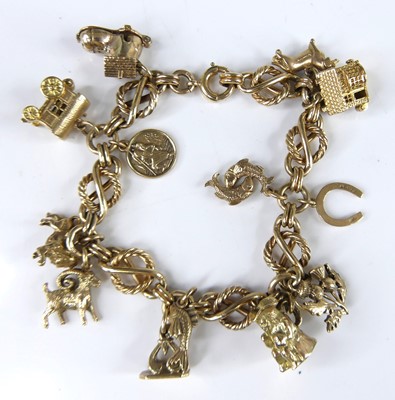 Lot 2641 - A ladies 9 carat gold charm bracelet, having...