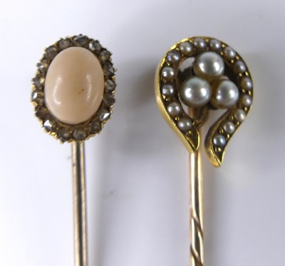 Lot 2654 - Two yellow metal stick pins, one designed as a...