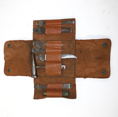 Lot 252 - An ammunition tin containing various items to...