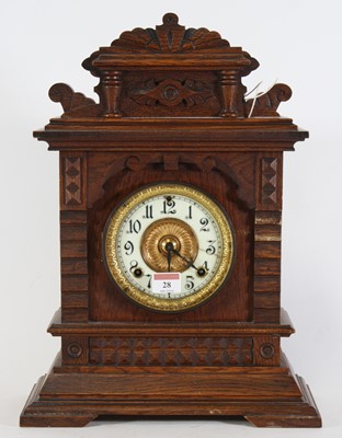 Lot 28 - A late 19th century American oak cased mantel...