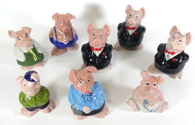 Lot 53 - A collection of eight Wade pottery piggy-banks,...