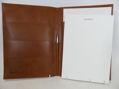 Lot 477 - A Jaeger LeCoultre tan leather notebook,...
