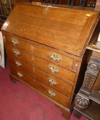 Lot 1224 - A George III provincial oak slopefront four...